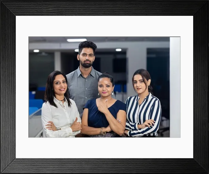 Framed Print : Four Indian office colleagues standing together with arms folded, office background, corporate environment Framed Print : Four Indian office colleagues standing together with arms folded, office background, corporate environment