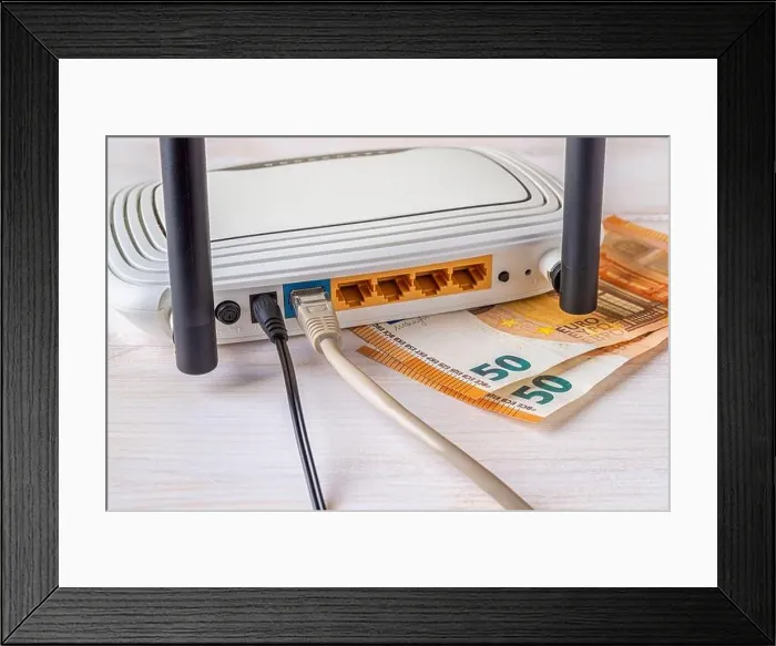 Framed Print : Two fifty euro bill banknotes and white Wi-Fi wireless router with connected cables on a white wooden desk Framed Print : Two fifty euro bill banknotes and white Wi-Fi wireless router with connected cables on a white wooden desk