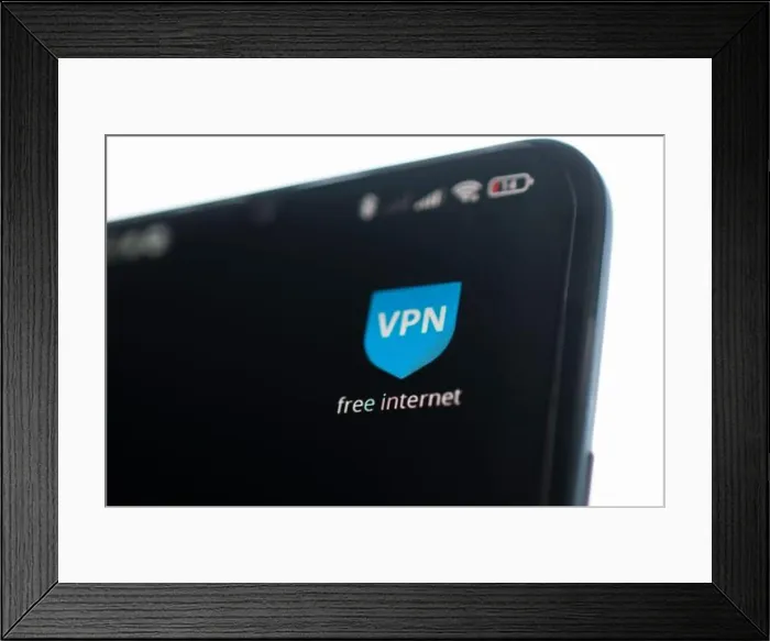 Framed Print : uses VPN application on smartphone Framed Print : uses VPN application on smartphone