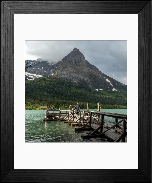 Framed Print : Glacier Nation park on a dock a man enjoys the warm rays of sun Framed Print : Glacier Nation park on a dock a man enjoys the warm rays of sun