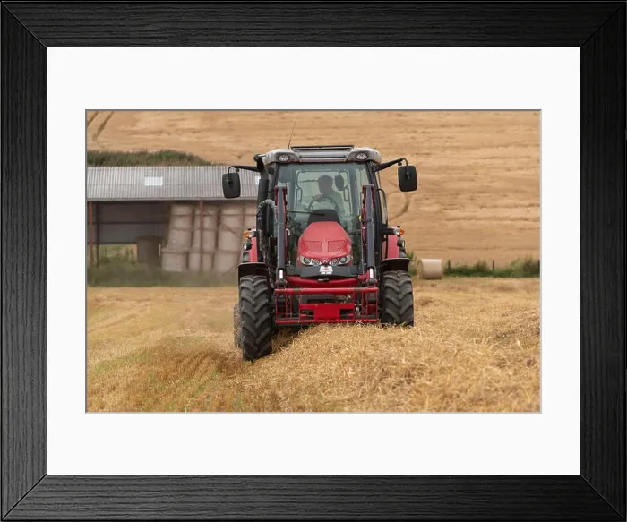Framed Print : A Front, or Head-On, View of a Farmer Baling Straw in a Field of Stubble Framed Print : A Front, or Head-On, View of a Farmer Baling Straw in a Field of Stubble