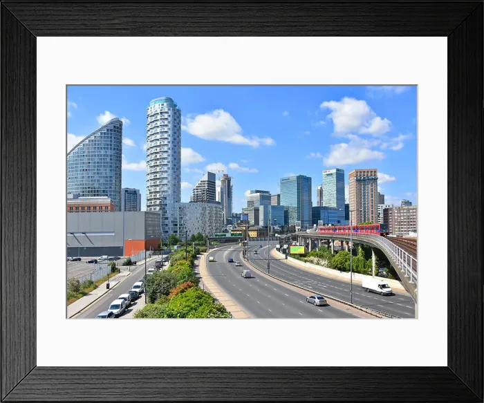 Framed Print : East End London high rise apartment building meet Canary Wharf financial district banking skyscraper skyline with road Framed Print : East End London high rise apartment building meet Canary Wharf financial district banking skyscraper skyline with road