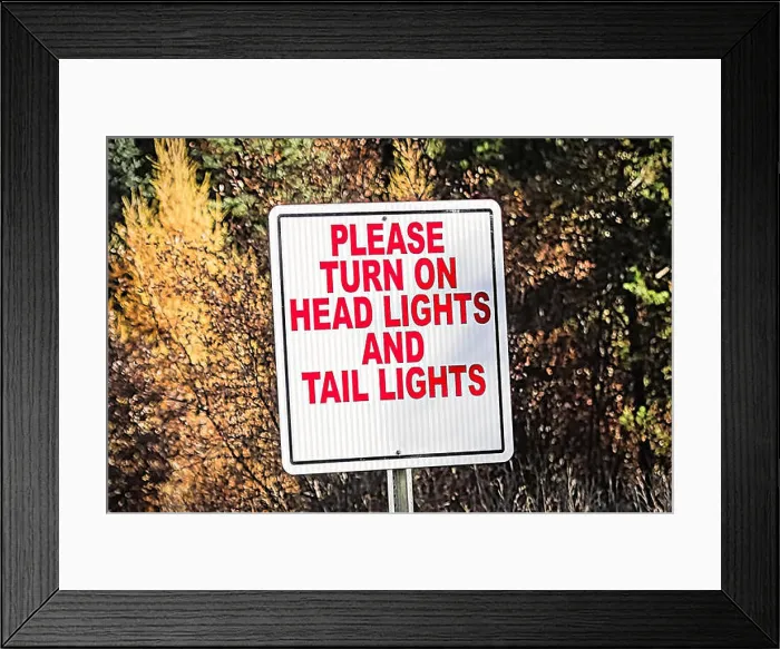 Framed Print : A sign indicating to turn on all vehicle lights