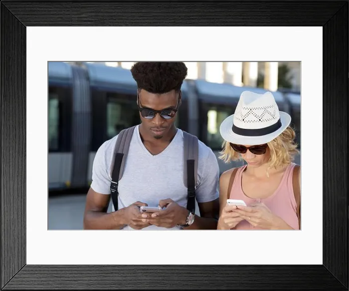 Framed Print : stupefied two mixed couple stares at smart phone Framed Print : stupefied two mixed couple stares at smart phone