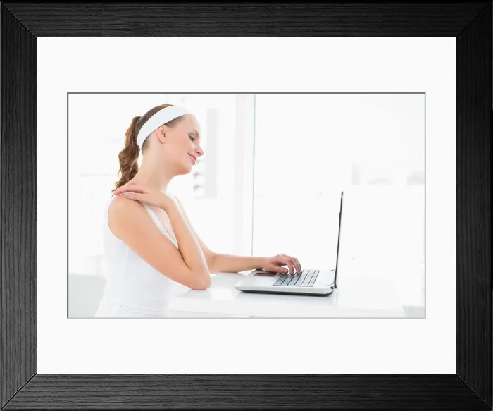 Framed Print : Concentrated pretty sportswoman typing on a laptop Framed Print : Concentrated pretty sportswoman typing on a laptop