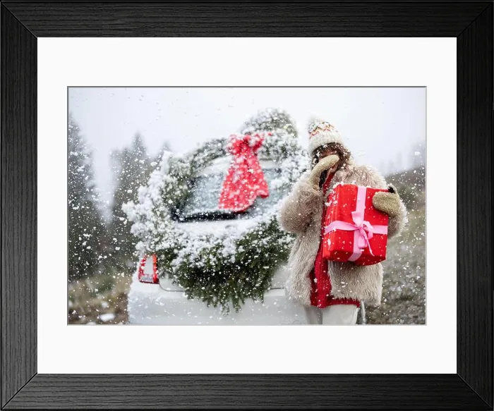 Framed Print : Woman travels by car with presents and Christmas wreath on the mountain road Framed Print : Woman travels by car with presents and Christmas wreath on the mountain road