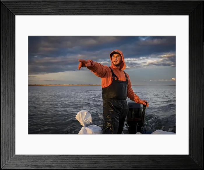 Framed Print : Commercial fisherman in boat pointing to something in the distance Framed Print : Commercial fisherman in boat pointing to something in the distance