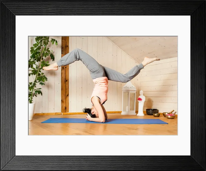 Framed Print : An image of a pretty woman doing yoga at home - Eka Pada Shirshasana