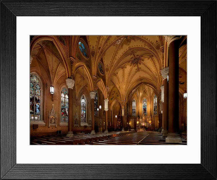 Framed Print : The interior of a historic 19th century Roman catholic church in Rochester city. Lit up. Stained glass windows Framed Print : The interior of a historic 19th century Roman catholic church in Rochester city. Lit up. Stained glass windows