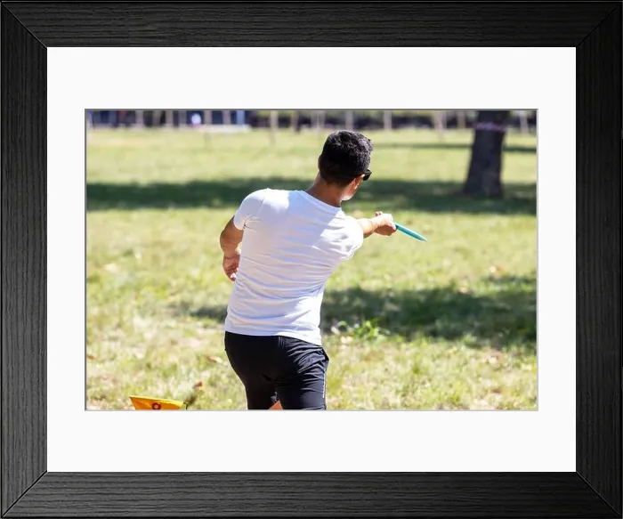 Framed Print : Man playing flying disc golf sport game in the park Framed Print : Man playing flying disc golf sport game in the park