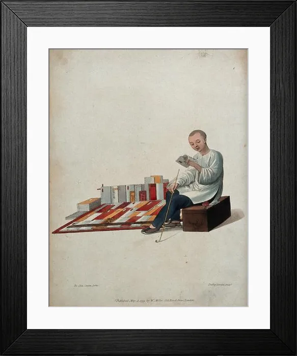 Framed Print : A Chinese bookseller seated on a box in the street Framed Print : A Chinese bookseller seated on a box in the street