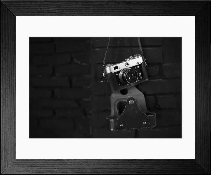 Framed Print : Old film camera on black wall. Image for design Framed Print : Old film camera on black wall. Image for design