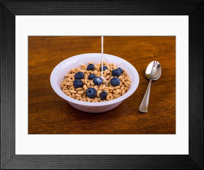 Framed Print : Pouring Milk on Oat Cereal with Blueberries Framed Print : Pouring Milk on Oat Cereal with Blueberries