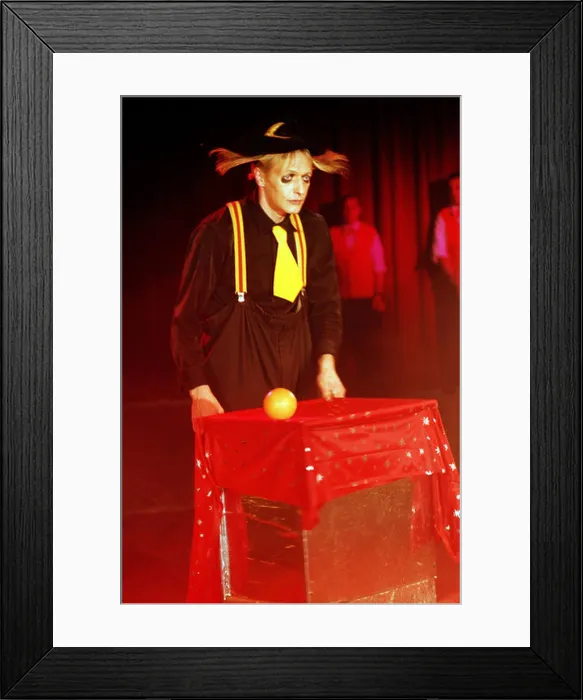 Framed Print : The Circus Clown shows magic tricks