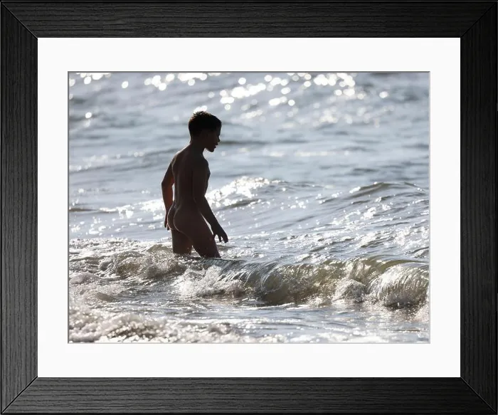 Framed Print : Naked young boy entering to sea, in sea waves Framed Print : Naked young boy entering to sea, in sea waves