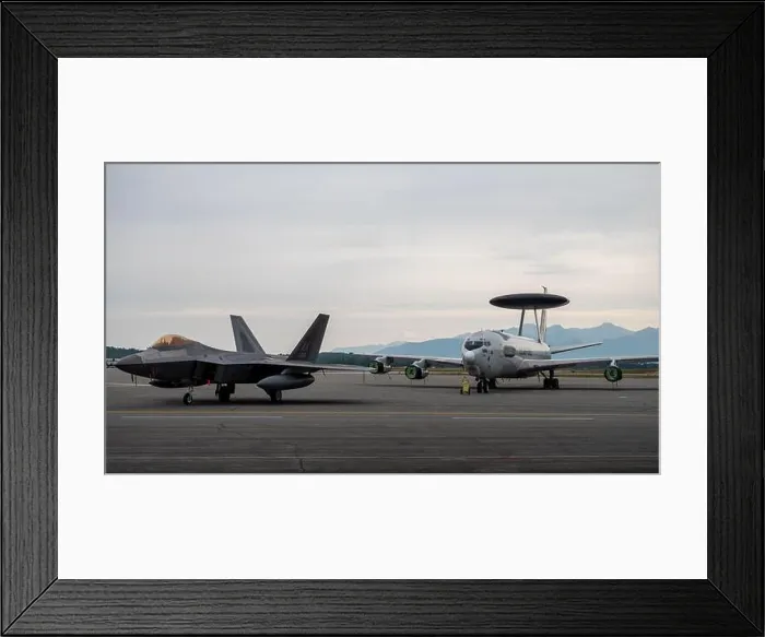 Framed Print : A U.S. Air Force F-22 Raptor sits next to an E-3 Sentry Airborne Warning Framed Print : A U.S. Air Force F-22 Raptor sits next to an E-3 Sentry Airborne Warning