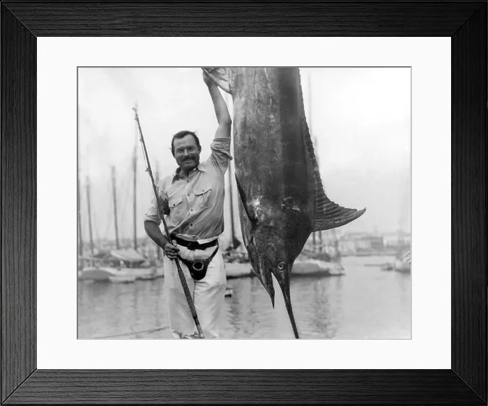 Framed Print : Ernest Hemingway (1899-1961) posing with a marlin at Havana Harbor, Cuba, July, 1934 Framed Print : Ernest Hemingway (1899-1961) posing with a marlin at Havana Harbor, Cuba, July, 1934