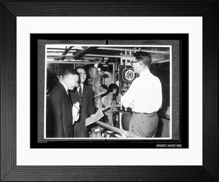 Framed Print : This image shows two men examining a display by the AWA (Amalgamated Wireless Australia) company on board a trade ship Framed Print : This image shows two men examining a display by the AWA (Amalgamated Wireless Australia) company on board a trade ship