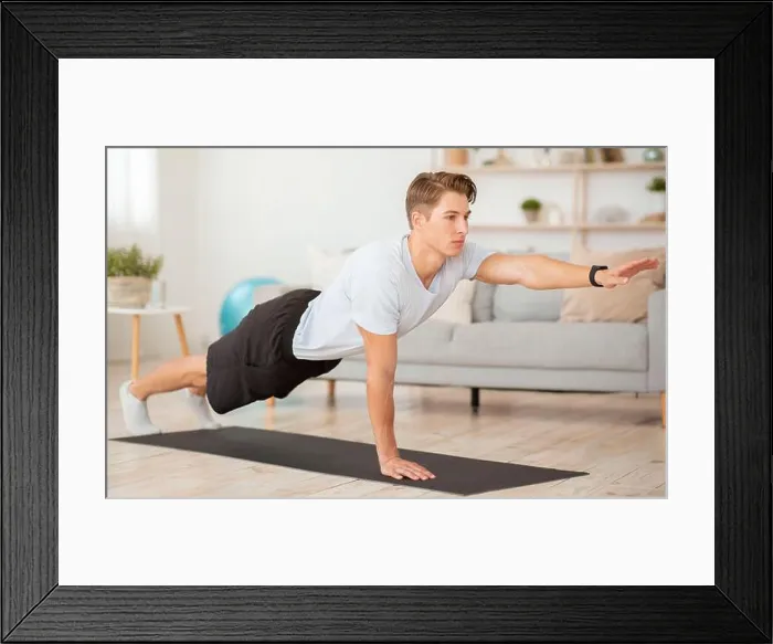 Framed Print : Body care at home and fitness. Young man with fitness tracker training Framed Print : Body care at home and fitness. Young man with fitness tracker training