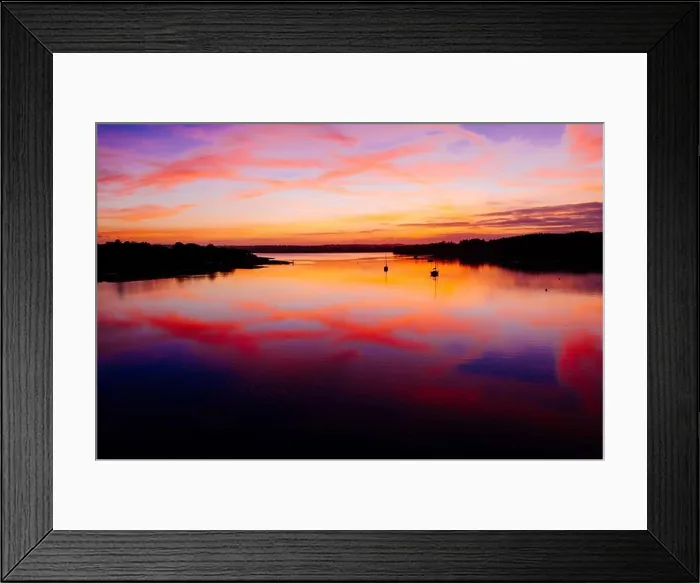 Framed Print : A dramatic sunset with a colorful cloudy sky and its reflection on a calm lake Framed Print : A dramatic sunset with a colorful cloudy sky and its reflection on a calm lake