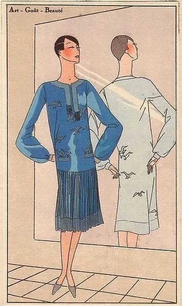 1920s woman in blue crepe dress embroidered with silver birds, pleated skirt, stading in front of a mirror