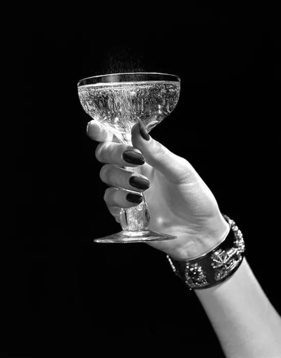 Framed Print : 1930s 1940s 1950s WOMAN HAND ORNATE METAL BRACELET HOLDING UP NEW YEAR TOAST GLASS OF CHAMPAGNE AGAINST BLACK BACKGROUND Framed Print : 1930s 1940s 1950s WOMAN HAND ORNATE METAL BRACELET HOLDING UP NEW YEAR TOAST GLASS OF CHAMPAGNE AGAINST BLACK BACKGROUND