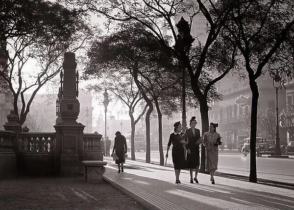 1930s 1940s SUNSET CREATES MOODY ATMOSPHERE FOR THREE WOMEN WALKING TOGETHER ALONG PLAZA CONGRESS BUENOS AIRES ARGENTINA - r12624 PAL001 HARS ALONG