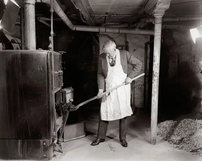 Framed Print : 1940s ELDERLY MAN IN BASEMENT WEARING APRON SHOVELING COAL INTO FURNACE Framed Print : 1940s ELDERLY MAN IN BASEMENT WEARING APRON SHOVELING COAL INTO FURNACE