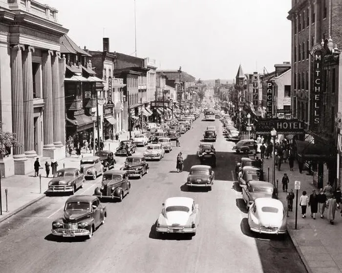 Framed Print : 1950s AUTOMOBILES AND PEDESTRIANS ON BUSY COMMERCIAL MAIN STREET IN NORRISTOWN PENNSYLVANIA USA - r5137 HAR001 HARS PERSONS SCENIC SHOPS UNITED