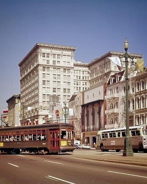 1960s 1970s TROLLEY STREETCAR TURNING FROM CARONDELET AND PUBLIC TRANSPORTATION BUS ON CANAL STREET NEW ORLEANS LOUISIANA USA - kr11095 GRD001 HARS