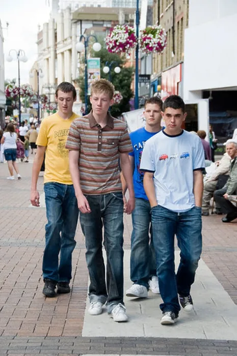 Framed Print : 2 teenage boys walking down the street with 2 more following them Framed Print : 2 teenage boys walking down the street with 2 more following them
