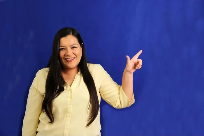 Framed Print : 40-year-old Latina woman points with the fingers of her hand to something that she likes Framed Print : 40-year-old Latina woman points with the fingers of her hand to something that she likes
