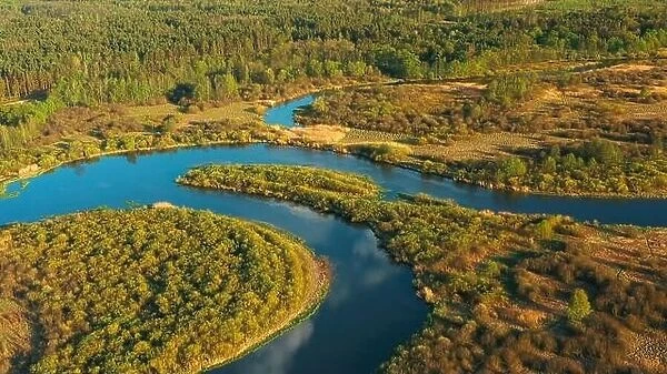 4K Aerial View Green Meadow And Forest On Coast Of Curved River Landscape In Sunny Summer Day. Top View Of Beautiful European Nature From Attitude