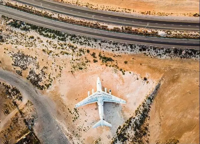 Framed Print : Abandoned airplane in the in the Umm Al Quwain desert in the emirate of the United Arab Emirates aerial view at sunrise Framed Print : Abandoned airplane in the in the Umm Al Quwain desert in the emirate of the United Arab Emirates aerial view at sunrise