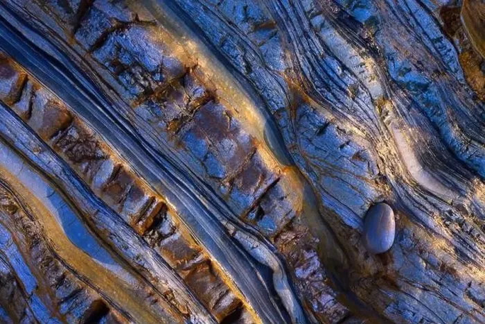 Framed Print : Abstract aerial view of textured rock formations with intricate laminations and a solitary pebble Framed Print : Abstract aerial view of textured rock formations with intricate laminations and a solitary pebble
