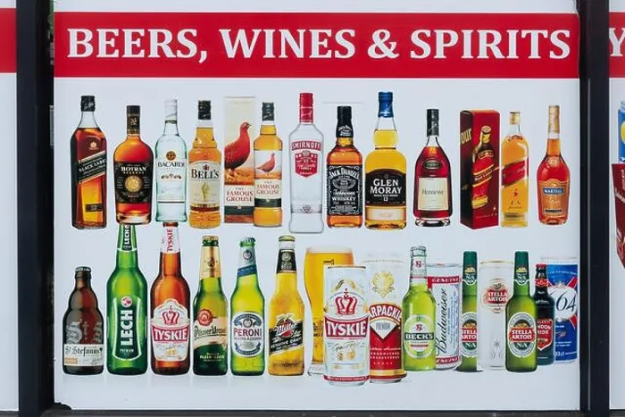 Framed Print : Advertising poster for beers, wines and spirits in the window of a convenience store, UK Framed Print : Advertising poster for beers, wines and spirits in the window of a convenience store, UK