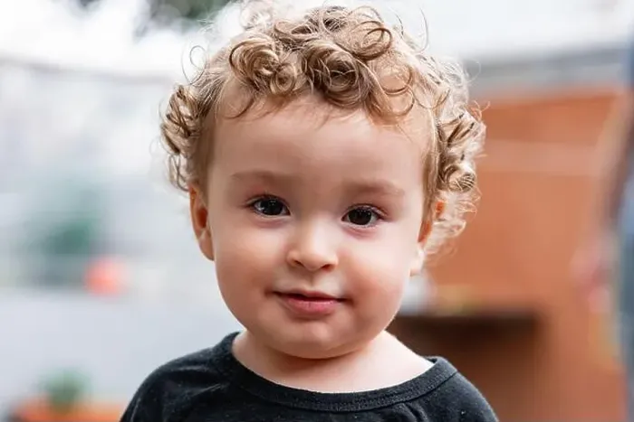 Framed Print : Adorable little kid with blond curly hair and brown eyes looking at camera on blurred background Framed Print : Adorable little kid with blond curly hair and brown eyes looking at camera on blurred background
