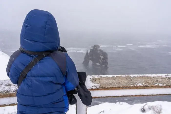 Framed Print : Adventurous woman in winter in Iceland looking at the frozen figure of Hvitserkur Framed Print : Adventurous woman in winter in Iceland looking at the frozen figure of Hvitserkur