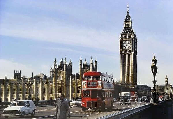 AEC Double-decker Routemaster bus on Westminster Bridge passing Big Ben, Houses of Parliament, London, ENGLAND, UK. Circa 1980's