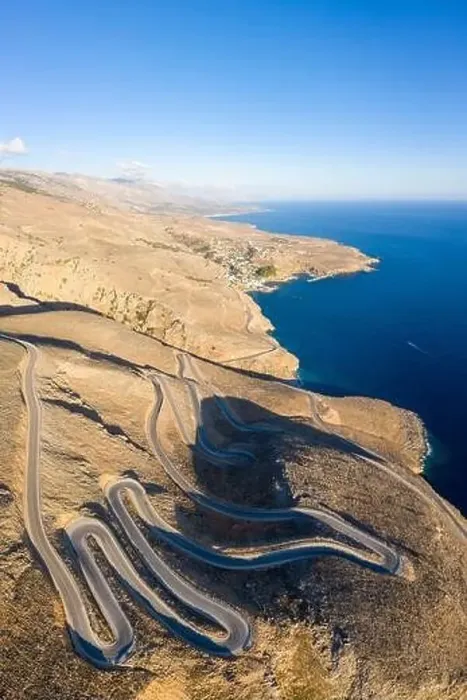 Framed Print : Aerial coastal view of the winding road between the towns of Hora Skafion and Anopolis on the south coast of Crete