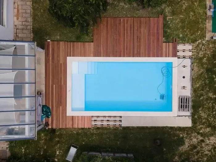 Framed Print : aerial drone flight over beautiful green garden with pool and the wooden deck of the pool is in progress Framed Print : aerial drone flight over beautiful green garden with pool and the wooden deck of the pool is in progress