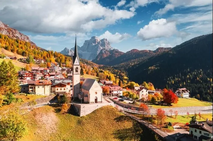 Framed Print : Aerial drone flight over San Lorenzo Catholic church in Selva di Cadore village. Biautiful small city in autumn Dolomites mountains Framed Print : Aerial drone flight over San Lorenzo Catholic church in Selva di Cadore village. Biautiful small city in autumn Dolomites mountains