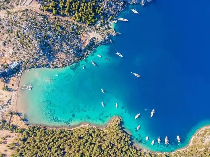 Framed Print : Aerial drone footage of daily tour boats and private yachts anchored in Cennet Bay Framed Print : Aerial drone footage of daily tour boats and private yachts anchored in Cennet Bay