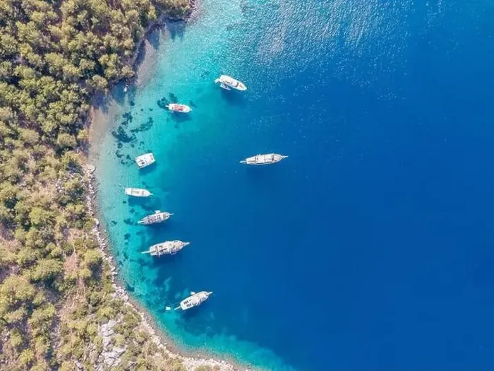 Framed Print : Aerial drone footage of daily tour boats and private yachts anchored in Cennet Bay Framed Print : Aerial drone footage of daily tour boats and private yachts anchored in Cennet Bay
