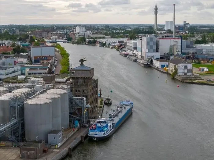 Framed Print : Aerial drone photo of a cargo barge docked at an industrial zone in Wormerveer, the Netherlands Framed Print : Aerial drone photo of a cargo barge docked at an industrial zone in Wormerveer, the Netherlands