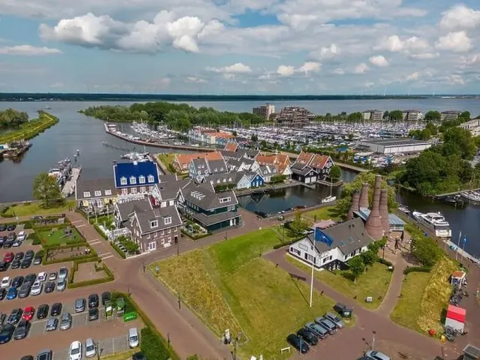Framed Print : Aerial drone photo of the dutch town Huizen in Utrecht. It has a large marina with typical dutch houses Framed Print : Aerial drone photo of the dutch town Huizen in Utrecht. It has a large marina with typical dutch houses