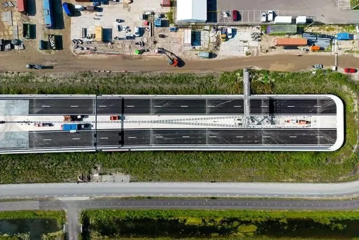 Framed Print : Aerial drone photo of a highway which goes into a tunnel seen from above Framed Print : Aerial drone photo of a highway which goes into a tunnel seen from above