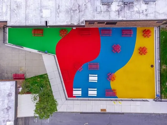 Framed Print : Aerial, drone, photo, of a red vinyl coated picnic tables on a multi color playground surface Framed Print : Aerial, drone, photo, of a red vinyl coated picnic tables on a multi color playground surface