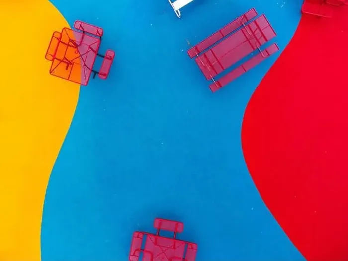 Framed Print : Aerial, drone, photo, of a red vinyl coated picnic tables on a multi color playground surface Framed Print : Aerial, drone, photo, of a red vinyl coated picnic tables on a multi color playground surface