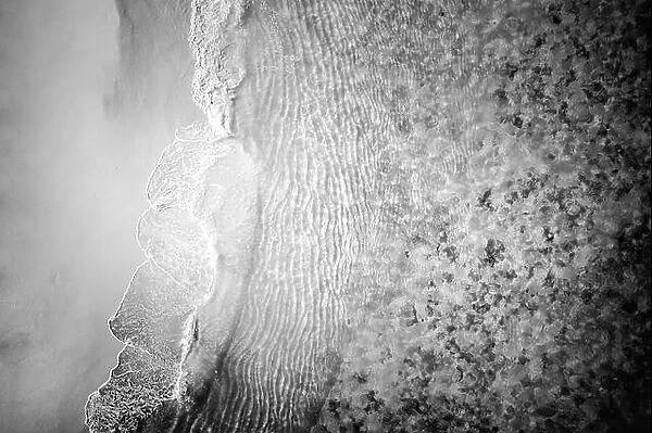 Aerial drone shoot from above black sand beach. Nature texture, monochrome process, beach landscape, tropical pattern